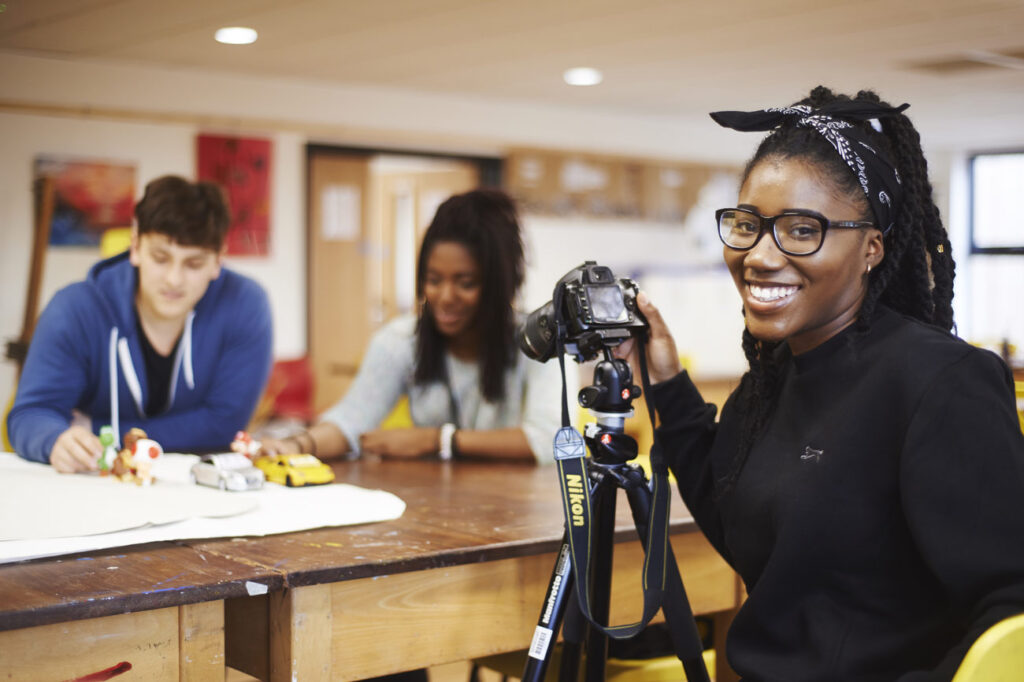 student doing photography in classroom