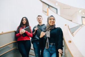 Portrait of teenage friends standing on steps