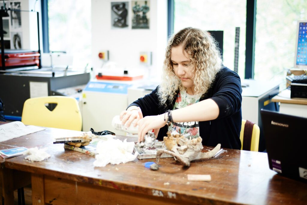 girl working on sculpture art