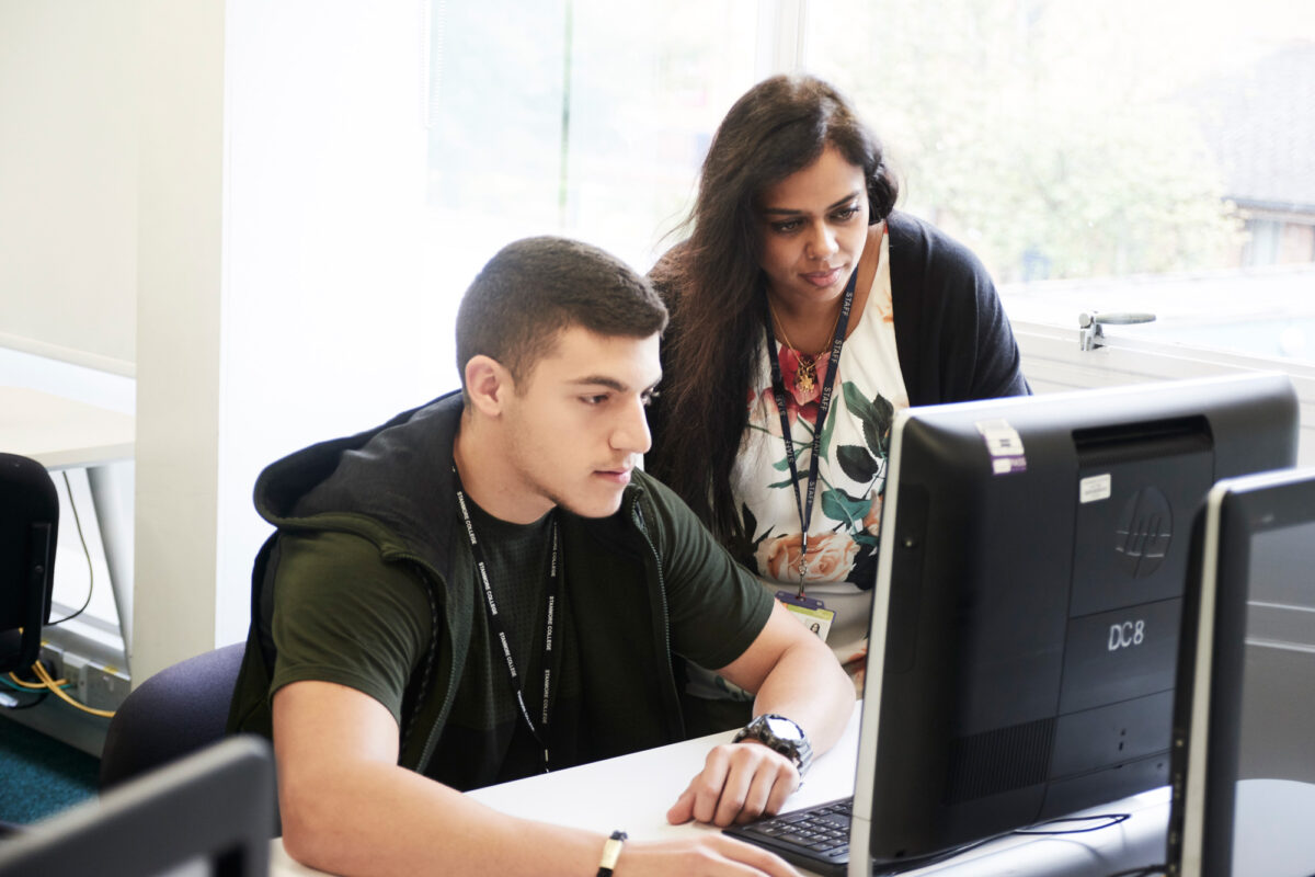 Stanmore College -teacher helping student library