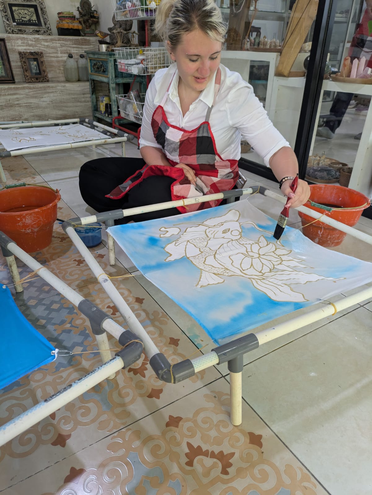 Girl student painting on canvas in Bali