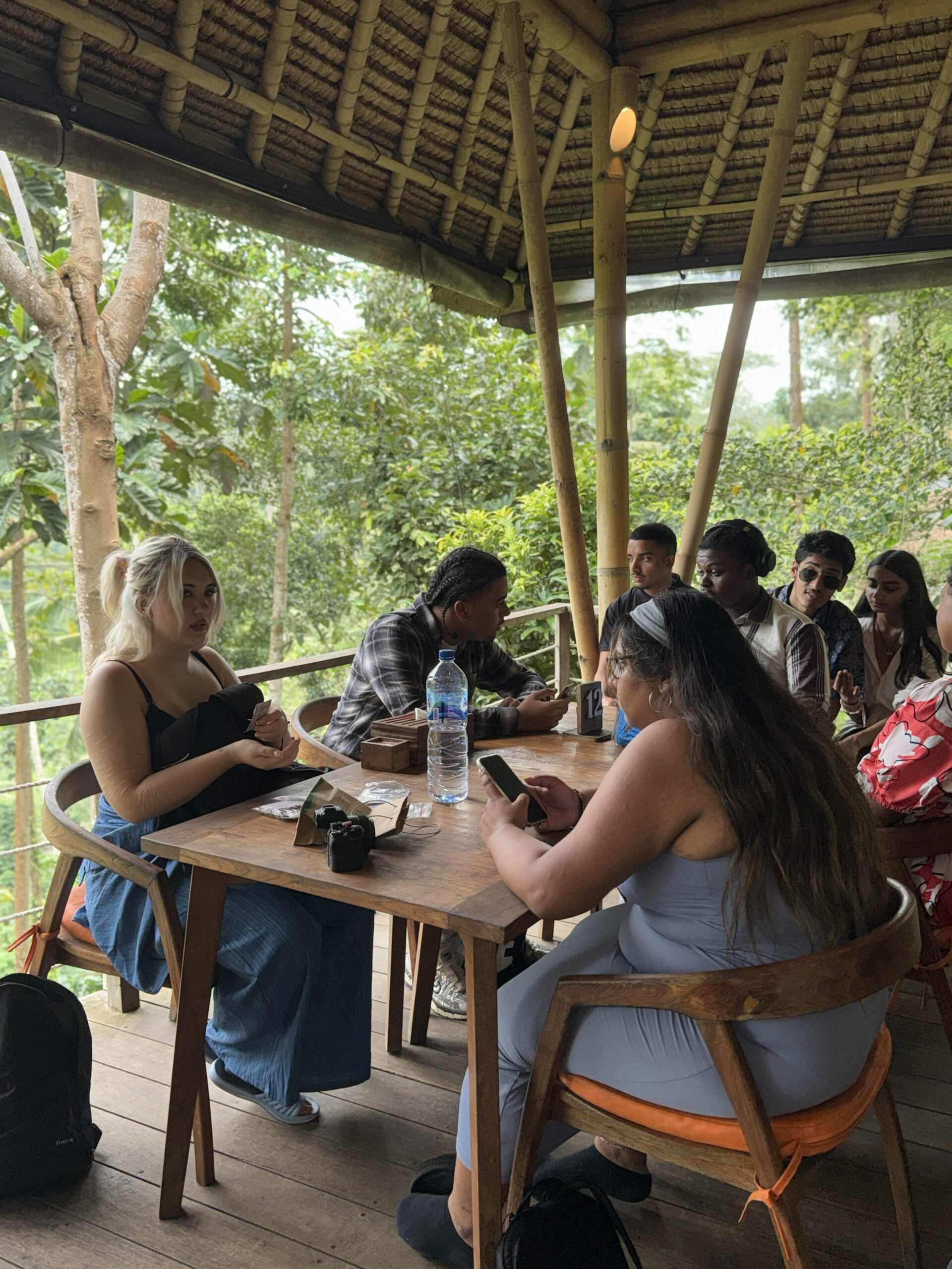 Students sitting around wooden table in Bali