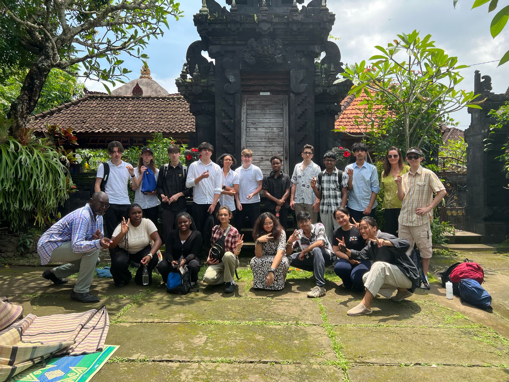 Stanmore College students gathered outside grand gates in Bali