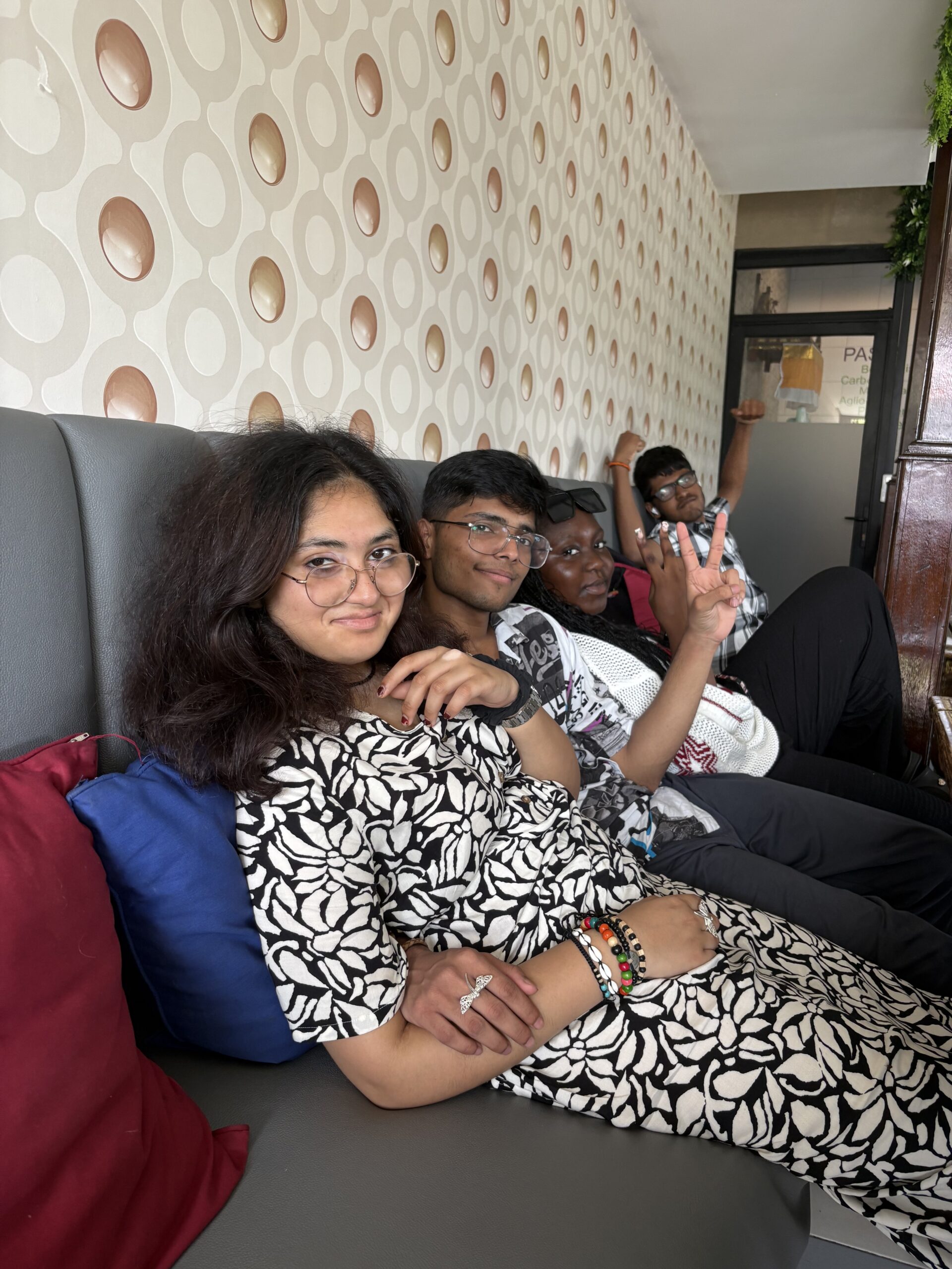 Stanmore College students relaxing on bench, smiling in Bali