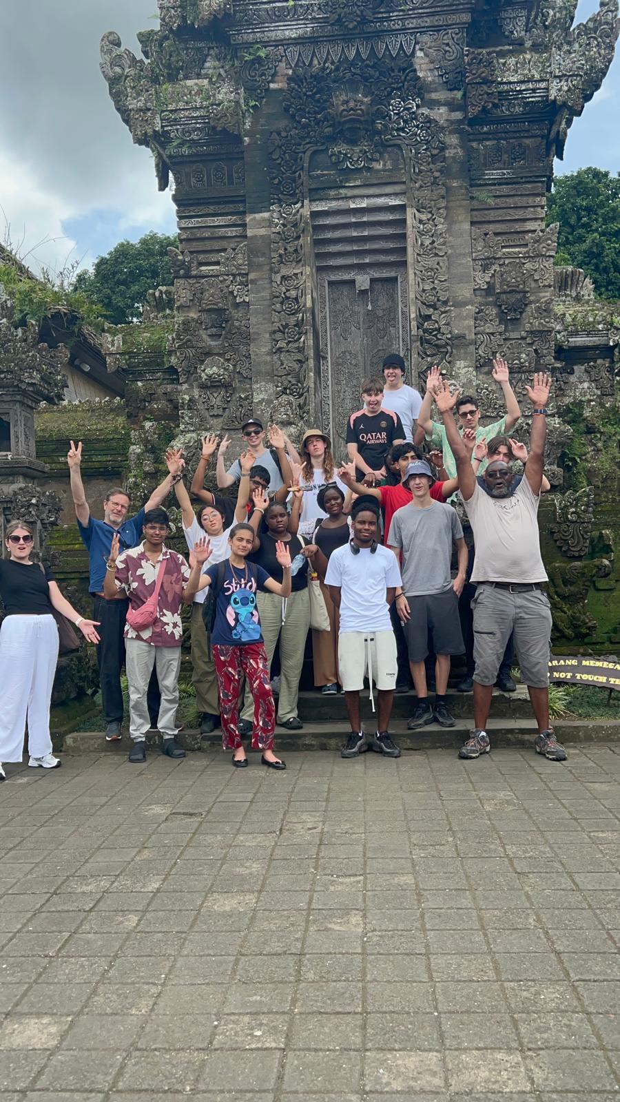 Group of students gathered for outside local building in Bali