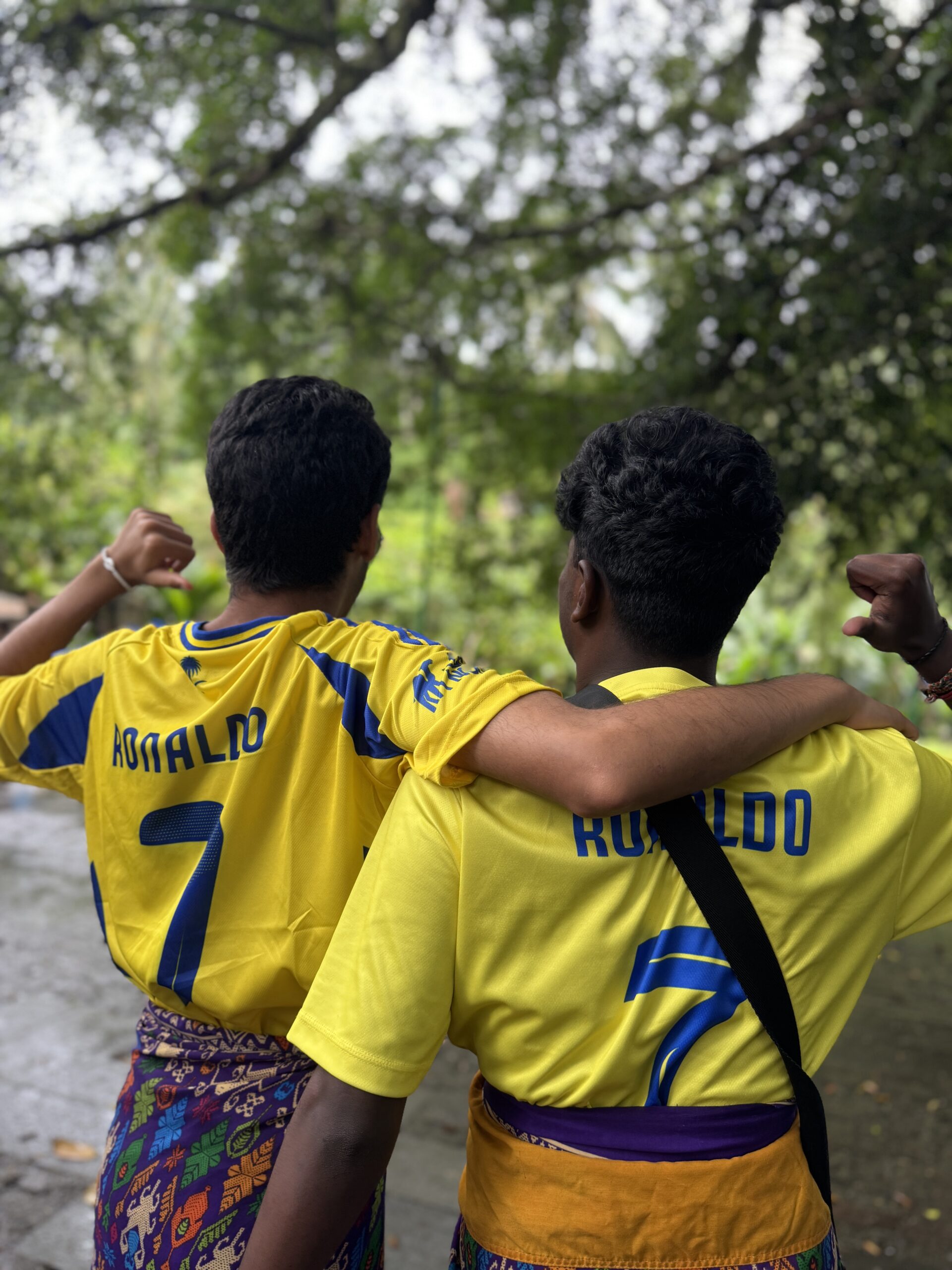 Stanmore College students with arms around each other in yellow football T-shirts in Bali