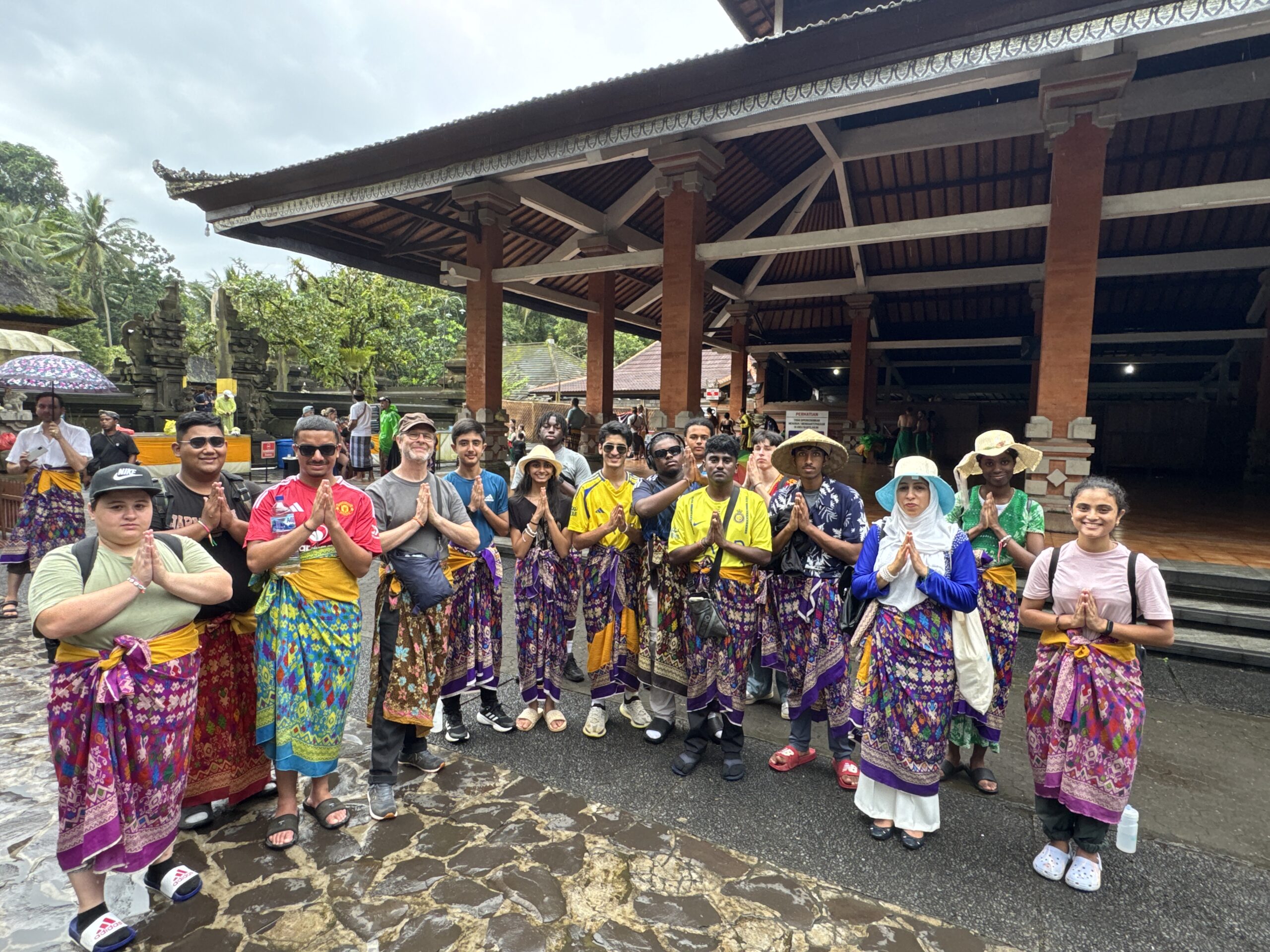 Stanmore College students and staff standing with hands together in Bali