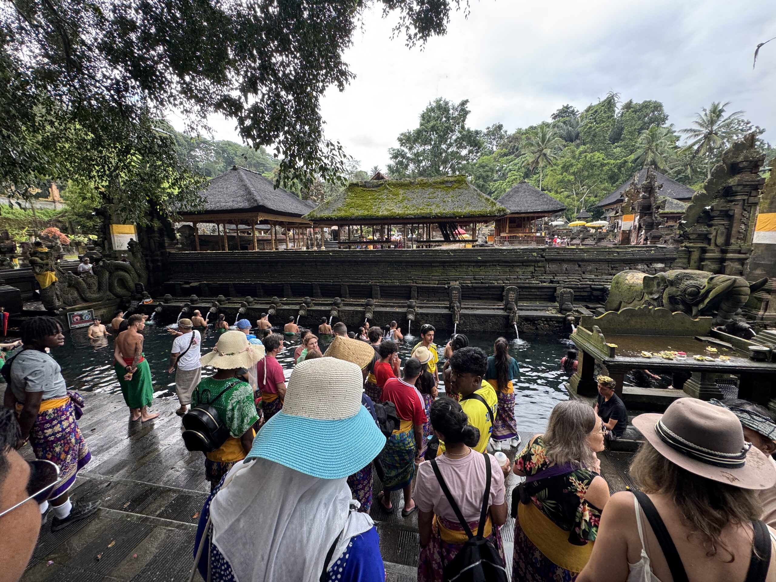 Stanmore College students walking around water and huts scenery in Bali