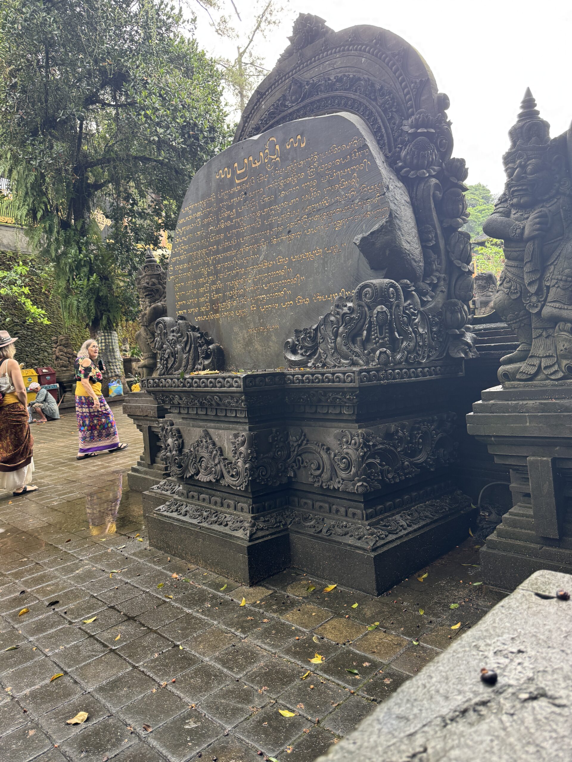 Artefacts and standing plaque with gold engraving in Bali