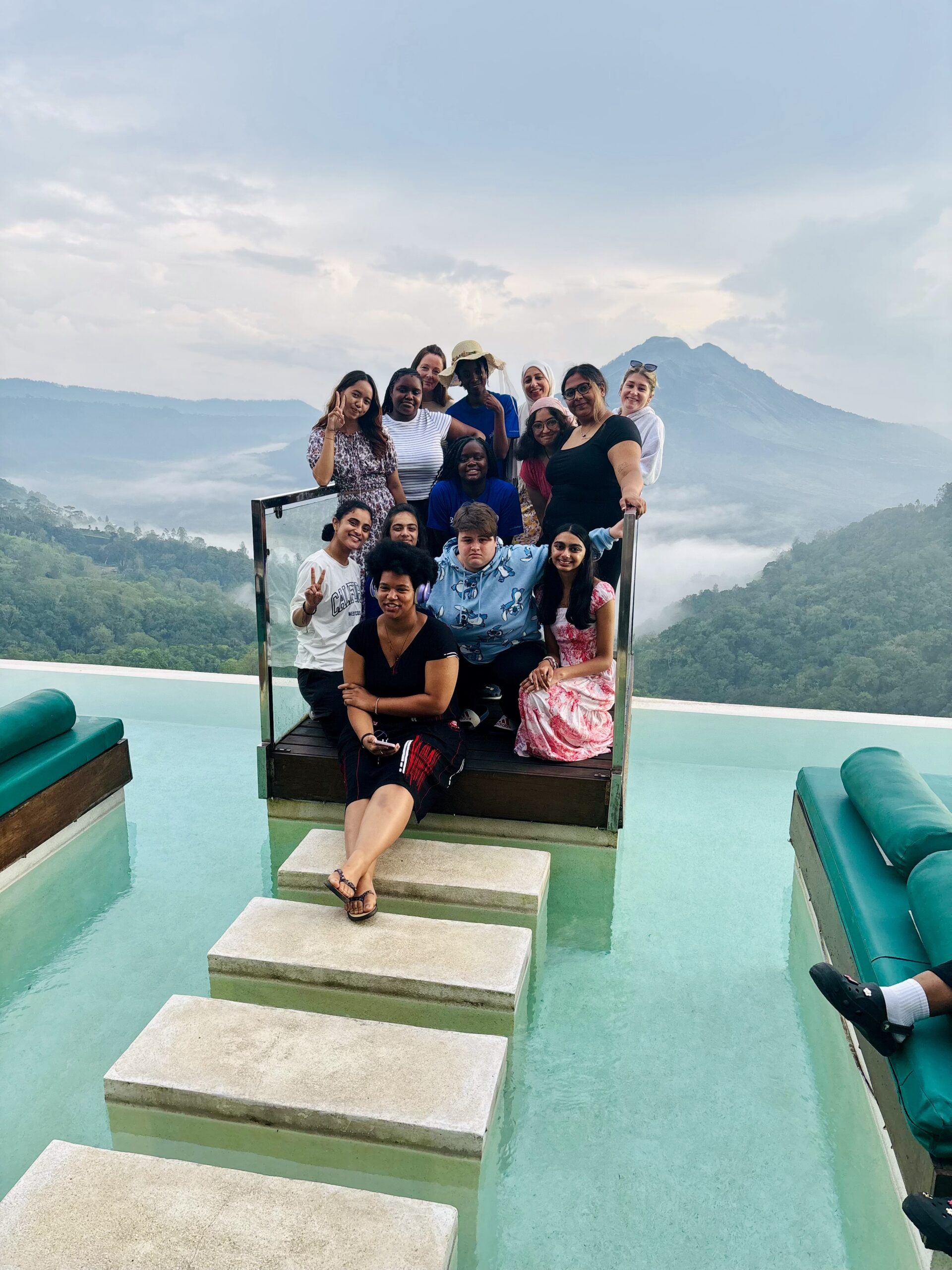 Students standing at edge of view bridge in Bali