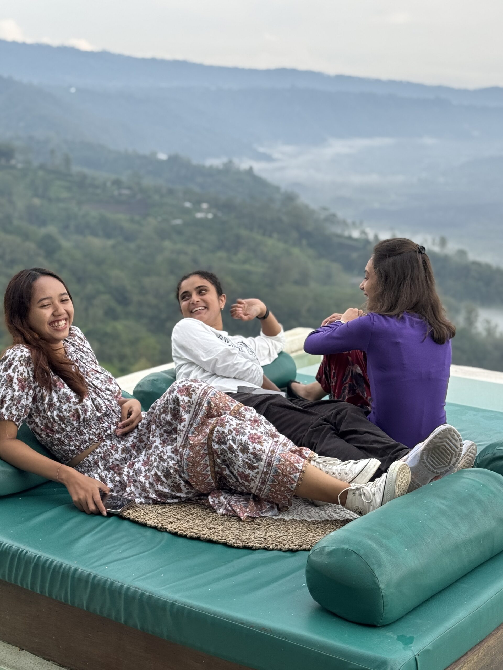 Students sitting and talking at edge of view point in Bali