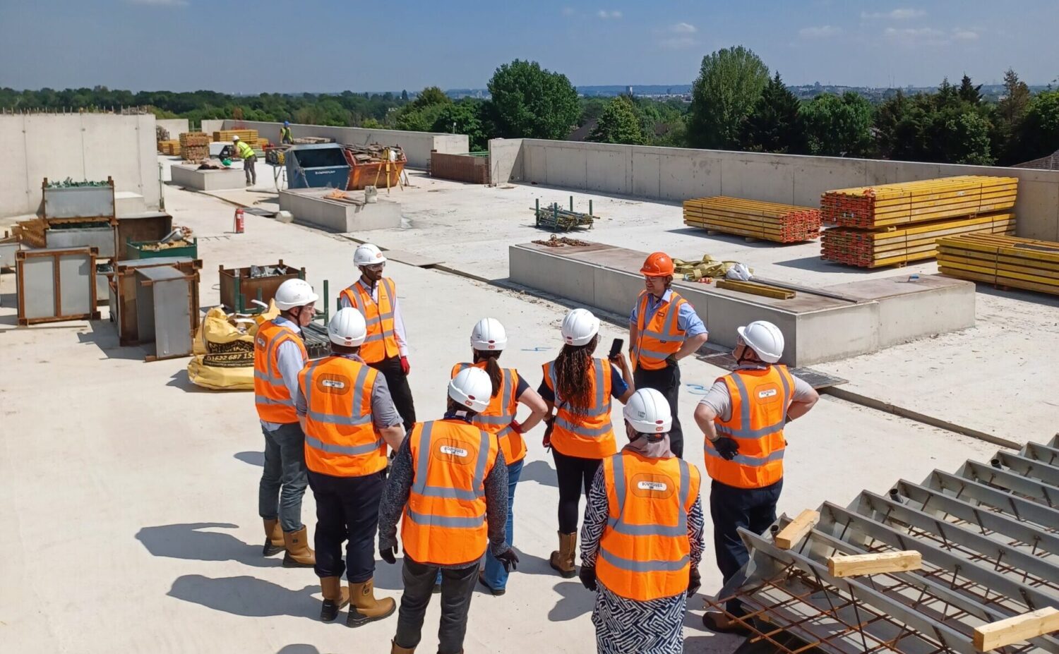 On the roof of block b on the new build, having a discussion regarding progress on site