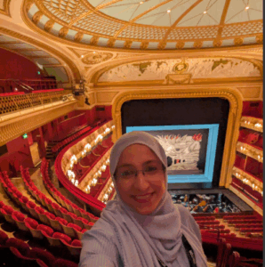 Woman with Royal Opera House stage behind her