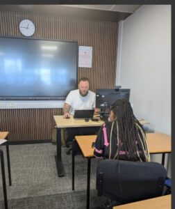 Teacher interviewing student at Stanmore College.