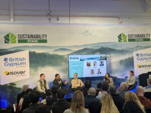 Speaking panel with screen behind them at London Building Expo