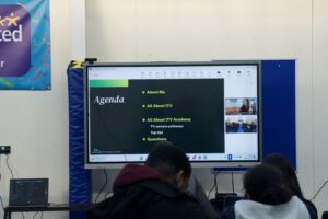 Stanmore College students watch onscreen talk by ITV Academy.