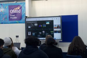 Stanmore College students watch onscreen talk by ITV Academy.