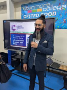 Ketan Dhattani giving talk at Stanmore College charity event.