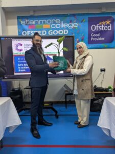 Ruhina gives certificate to Ketan at College Charity event.