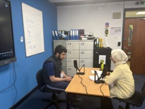 Staff interviewing Stanmore College student.