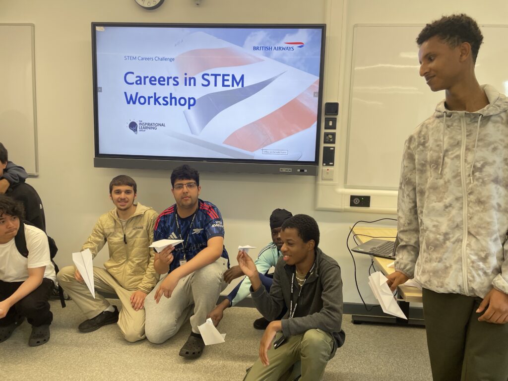 Stanmore College Engineering students in front of British Airways presentation screen.