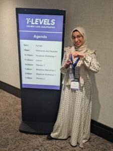 Stanmore College staff member Ruhina in front of T Level Agenda poster at National T Levels Conference, June 2026.